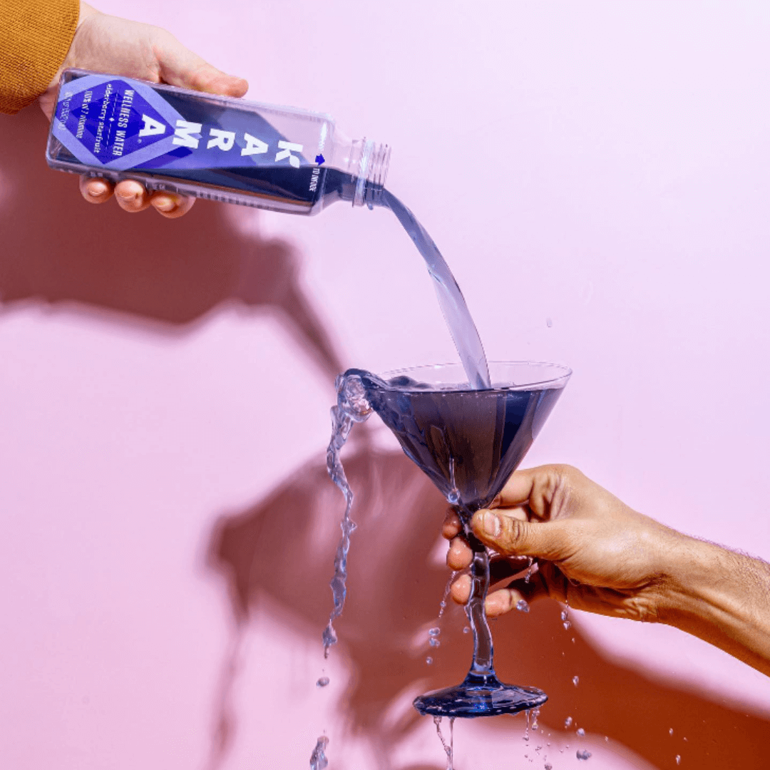 karma wellness water pouring into martini glass