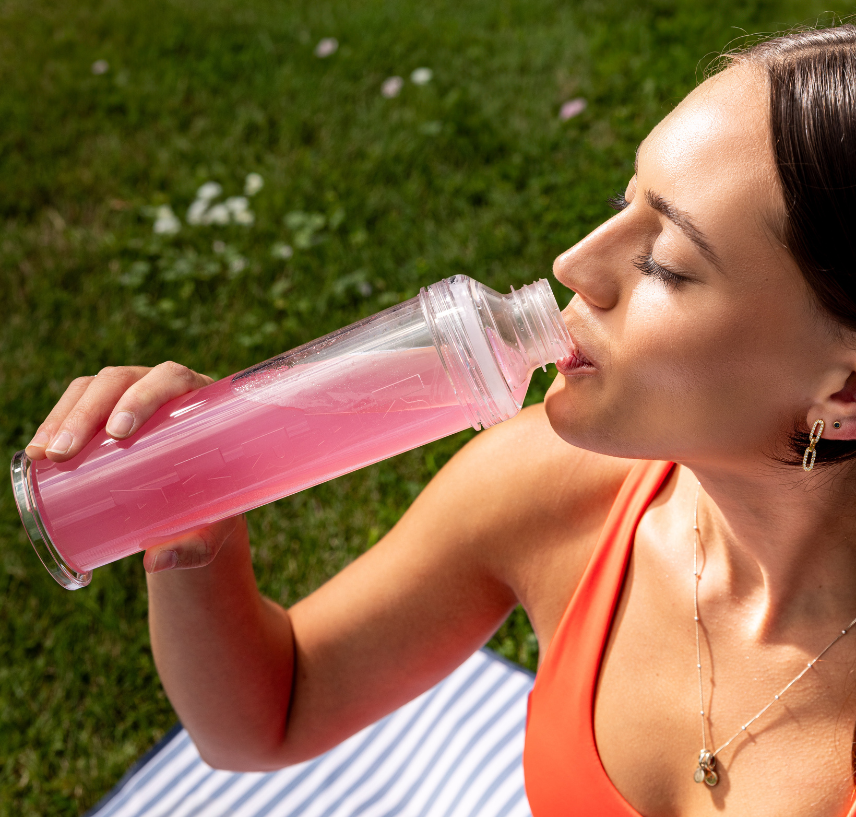 Brunette drinking from reusable Karma Water bottle